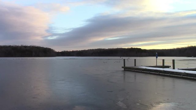 Burke Lake in Northern, Virginia is a wildlife sanctuary in the middle of a densely populated area.  This footage looks East towards the sunrise in late January.