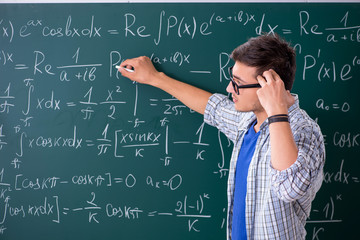 Young male student studying math at school - obrazy, fototapety, plakaty