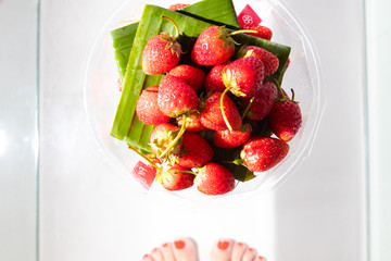 Fresh red strawberries on glass table. Place for text.