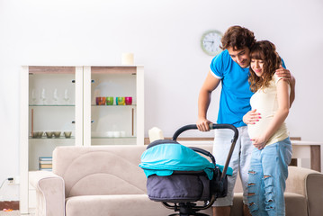 Young parents with baby expecting new arrival