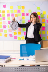 Young beautiful businesslady in conflicting priorities concept 