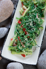 Chuka salad with crab meat and cucumber, elevated view, closeup, vertical shot