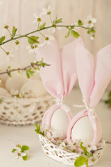 Happy easter. Decor of Easter eggs in small white baskets.