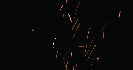hot sparks from charcoal moving up on black background