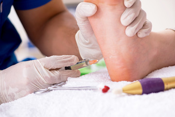 Podiatrist treating feet during procedure