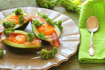 Breakfast. Avocado Egg Boats with crunchy bacon, kale cabbage