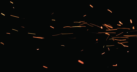hot sparks floating from side on black background - Powered by Adobe