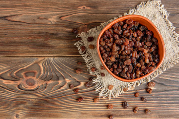 Raisins on wooden background.