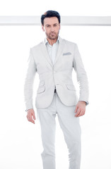 in full growth. confident businessman standing near the office window