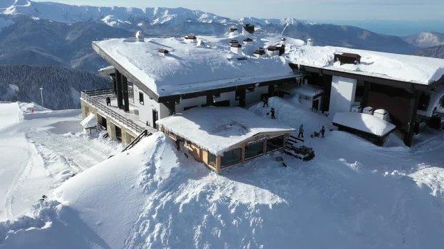 Krasnaya Polyana, Sochi. Mountains, snow, skiers, snowboarders, tourists. Vacation in the mountains. Clean air. Aerial photography with quadcopter.