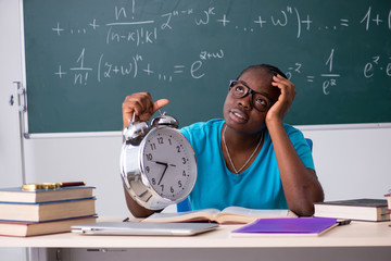 Black female student in front of chalkboard  