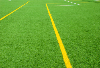 Football field green background with white and yellow line. Sport texture.