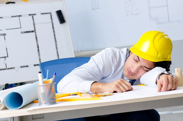 Young handsome architect working on the project 