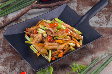 Fried celery with beef tripe in a plate in shape of spade