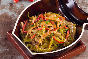 Sauteed pickled cabbage with shredded pork in a ceramic dish