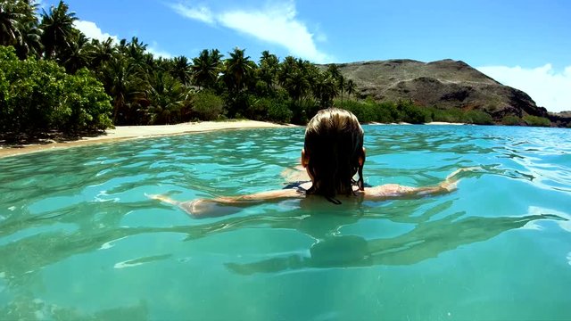 Female on a deserted Island beach Tahuata Marquesas