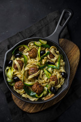 Pasta with meatballs on skillet