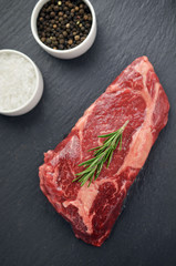 Raw steak with spices on the table