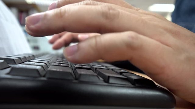 Typing on keyboard close up 