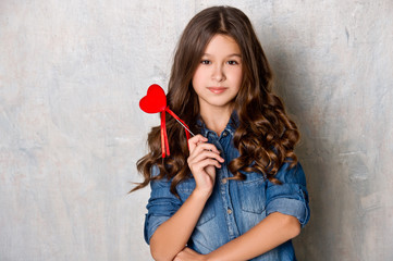 Valentine's Day. Beautiful girl with red heart.
