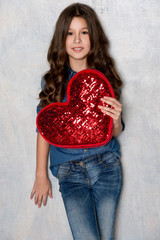 Valentine's Day. Beautiful girl with red heart.
