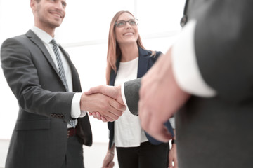 Business shaking hands in the office