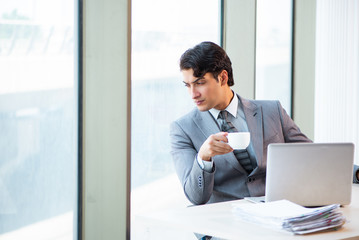 Fototapeta premium Young successful businessman working at the office 