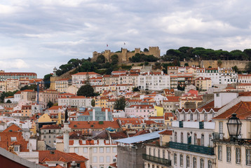 Fototapeta na wymiar Panoramic view at historical buildings and Castle of Saint George, Portugal, Lisbon. Cityscape of Lisboa. European buildings and architecture. Travel concept. Aerial view of Lisbon.