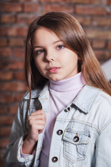 Portrait little fashion kid. Children's fashion concept. Stylish hipster girl looks confident,...