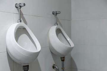 closeup old urinals (chamber pot) in toilet with soft-focus and over light in the background