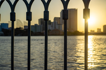 Bokeh of a Fence with Saigon River and Sunset in the Background
