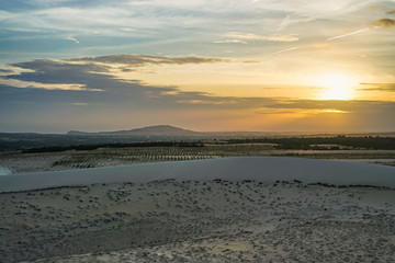 Sunset in the White Sand Dunes in Mui Ne, Vietnam with Cloudy Sky