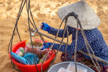 Vietnamese Woman Selling Food at the Red Sand Dunes in Mui Ne, Vietnam