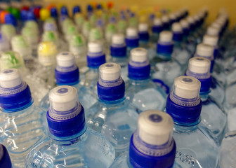 Plastic water bottles with caps of different colour