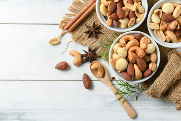 salted cocktail nuts on white wood