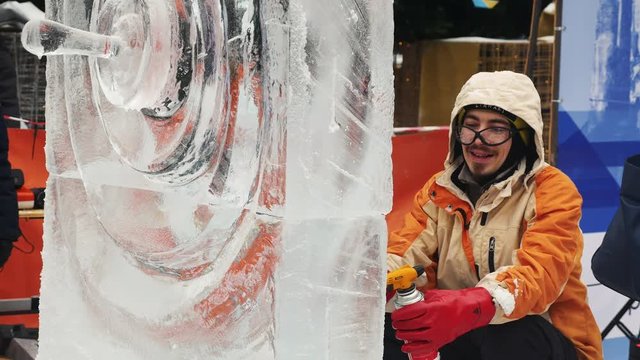 The sculptor creates an ice sculpture