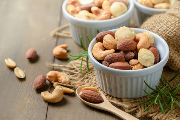 salted cocktail nuts on wood background,
