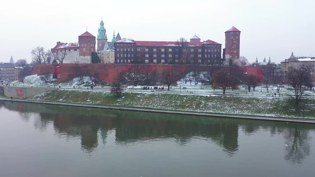 Aerial view of Wawel royal Castle and Cathedral, Vistula River, park, promenade and walking people in winter. Poland
