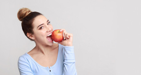 Healthy eating. Pretty girl biting fresh apple