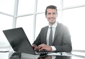 smiling businessman sitting at his Desk