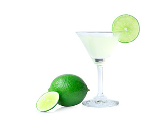 Glass of lime juice and lime fruits with green leaves isolated on white background