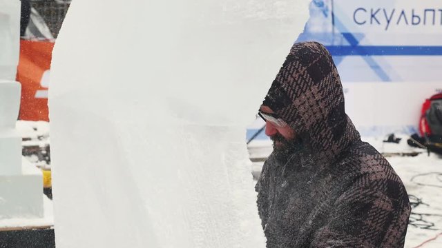 The sculptor creates an ice sculpture
