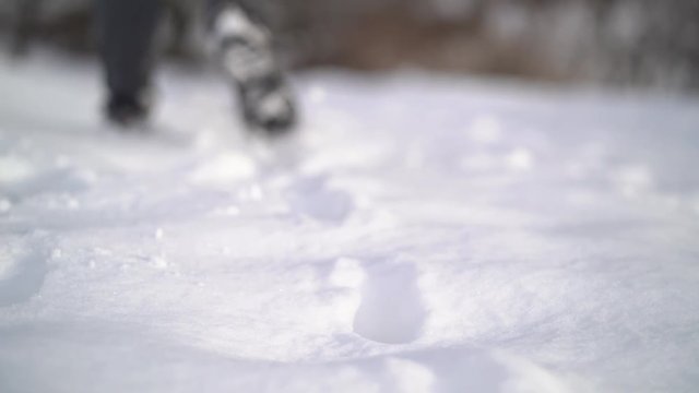 Slow motion video. foot feet steeps. hiking walking. slow motion. snow winter landscape. recreation activity. holiday vacation tourism. people persons. outdoors sports