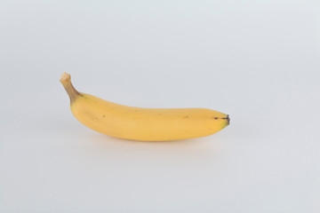 a tasty yellow banana with a white background