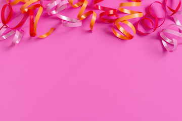 Bright festive pink background with streamers