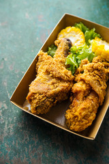 Fried chicken on wooden background.