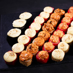 seafood restaurant, sushi menu, Japanese culture, food background, tasty delicious appetizing  baked rolls covered with melting cheese and torched salmon