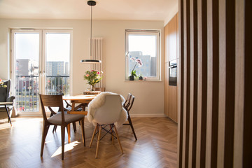 Modern scandinavian open space interior of kitchen and dining room with design furniture, black...
