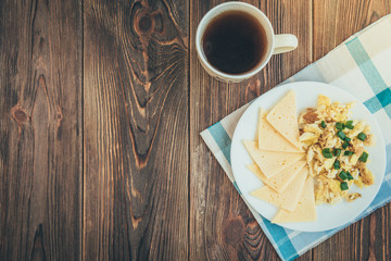 Omelet with cheese on wooden background. 