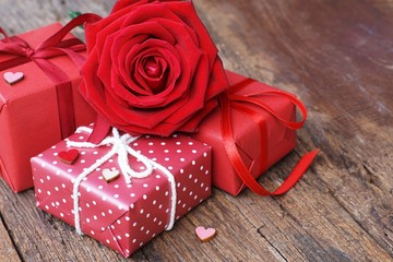 Group of lovely blooming red color rose flower on wood table background decorated with mini red heart figure, sweet valentine present concept